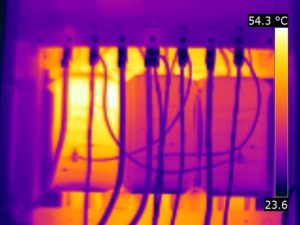 Thermal imaging of an anomaly on a 150kVA dry-type transformer indicating an overloaded left coil (54°C/130°F)